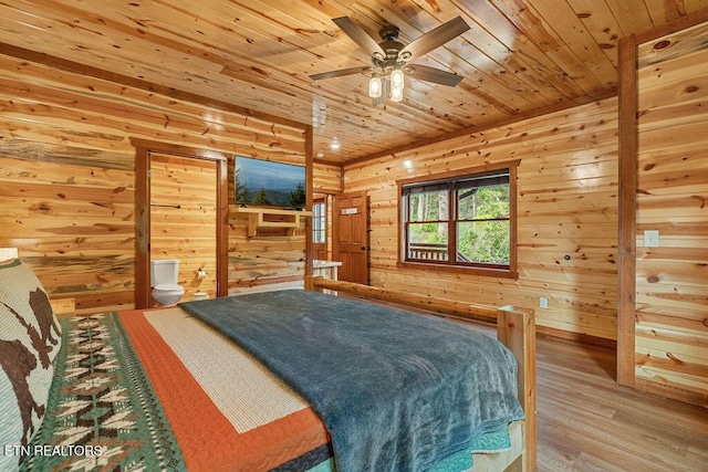 bedroom featuring wooden ceiling, wood finished floors, and wooden walls