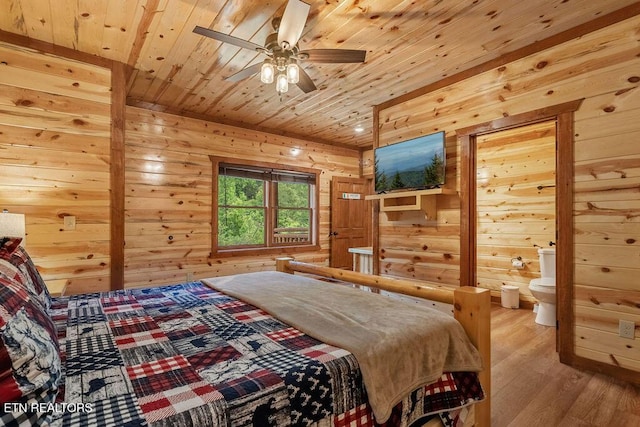 bedroom featuring wooden walls, light wood-type flooring, wooden ceiling, and connected bathroom