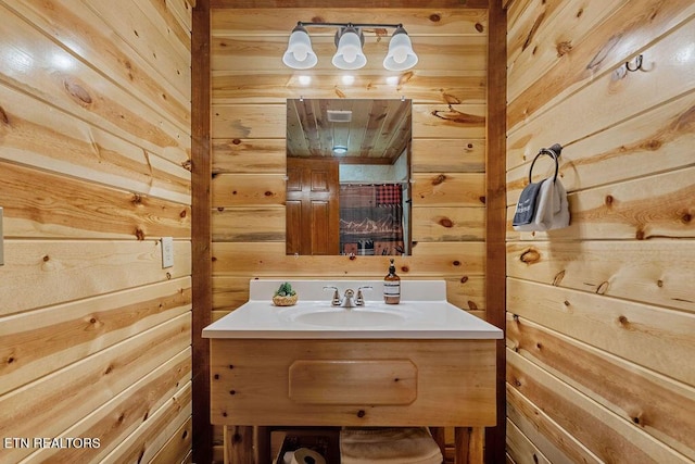 bathroom with wooden walls and vanity