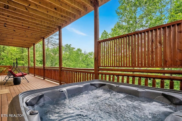 wooden deck featuring a hot tub