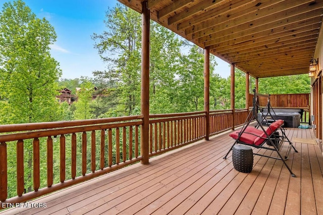 wooden deck with a hot tub