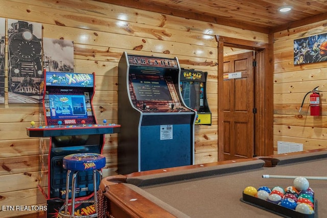 rec room featuring wood walls and wood ceiling