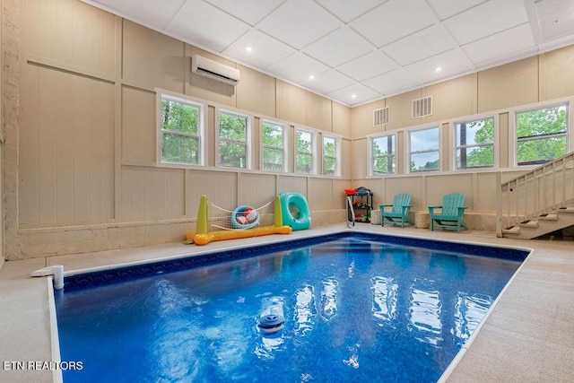 indoor pool featuring an AC wall unit