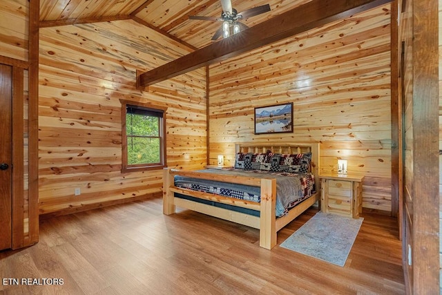 bedroom featuring wood walls, wood ceiling, wood finished floors, and vaulted ceiling