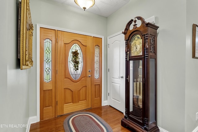 entrance foyer featuring wood finished floors and baseboards