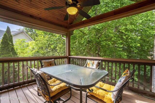 deck featuring outdoor dining area and ceiling fan