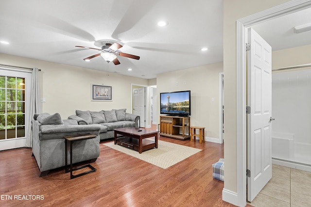 living room with a ceiling fan, wood finished floors, recessed lighting, and baseboards