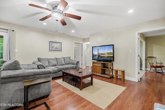 living area featuring a ceiling fan, wood finished floors, recessed lighting, and baseboards