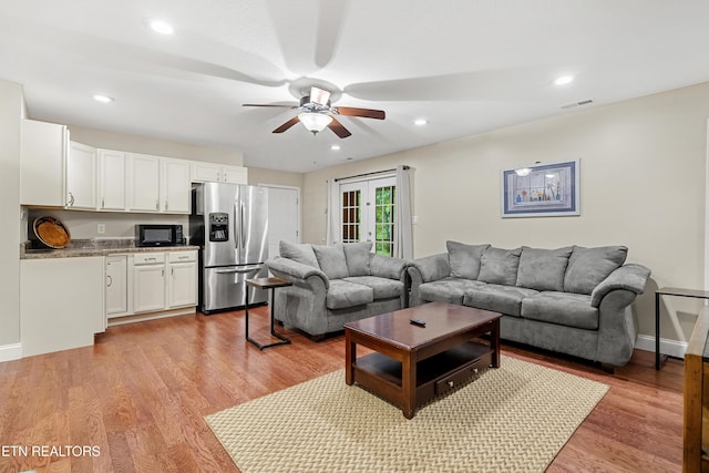 living area with ceiling fan, light wood-type flooring, recessed lighting, and baseboards