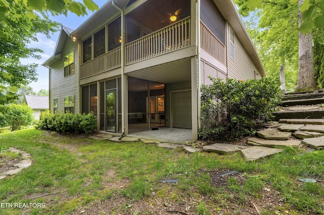 rear view of property featuring a sunroom