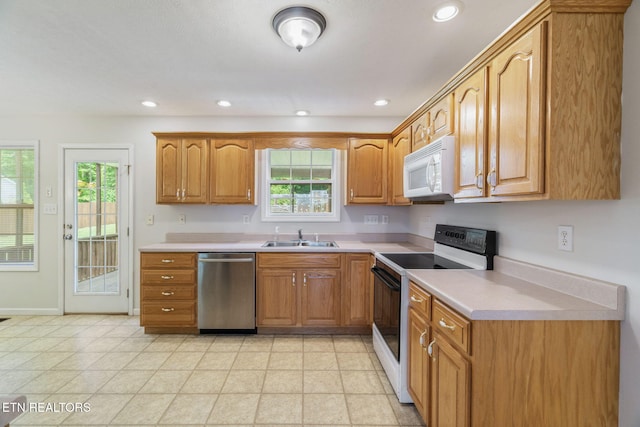 4419 Alder Tree Ln, Knoxville, TN 37938 - kitchen with electric range, white microwave, dishwasher, a sink, and healthy amount of natural light