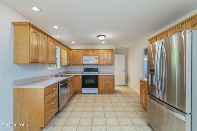 4419 Alder Tree Ln, Knoxville, TN 37938 - kitchen with stainless steel appliances, a sink, light countertops, recessed lighting, and brown cabinetry