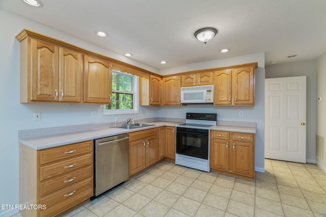 4419 Alder Tree Ln, Knoxville, TN 37938 - kitchen with stainless steel dishwasher, electric range oven, white microwave, a sink, and light countertops