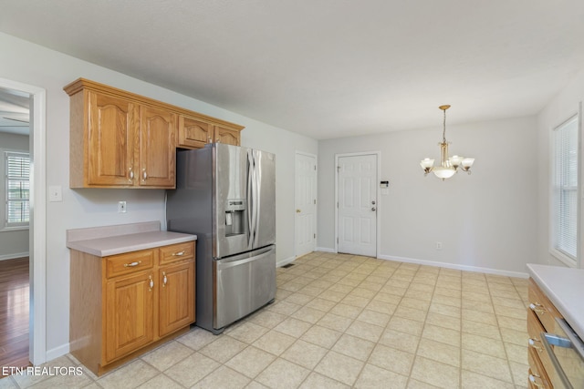 4419 Alder Tree Ln, Knoxville, TN 37938 - kitchen featuring stainless steel refrigerator with ice dispenser, a chandelier, light countertops, and baseboards