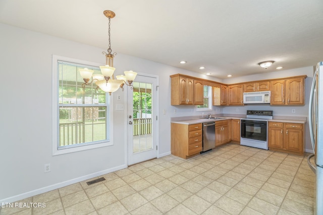 4419 Alder Tree Ln, Knoxville, TN 37938 - kitchen featuring stainless steel appliances, a chandelier, light countertops, recessed lighting, and decorative light fixtures