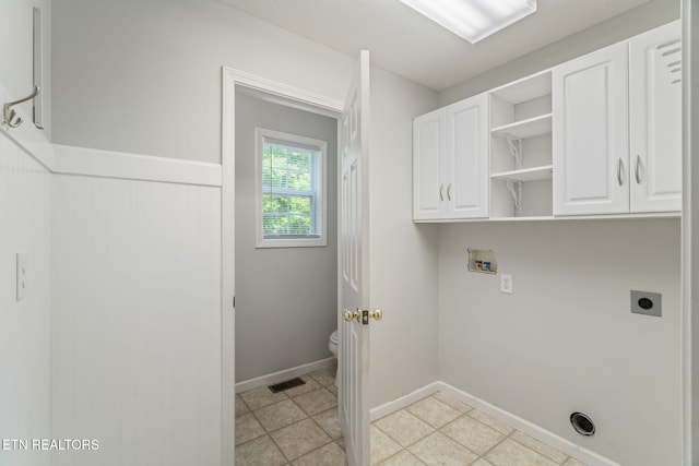 4419 Alder Tree Ln, Knoxville, TN 37938 - laundry area with hookup for an electric dryer, cabinet space, washer hookup, wainscoting, and baseboards