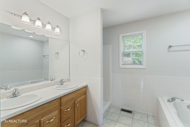 4419 Alder Tree Ln, Knoxville, TN 37938 - bathroom with tile walls, tile patterned flooring, a garden tub, double vanity, and wainscoting