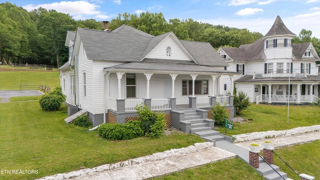 313 W Spring St, Oliver Springs, TN 37840 - victorian home featuring a porch, a front yard, a shingled roof, and cooling unit