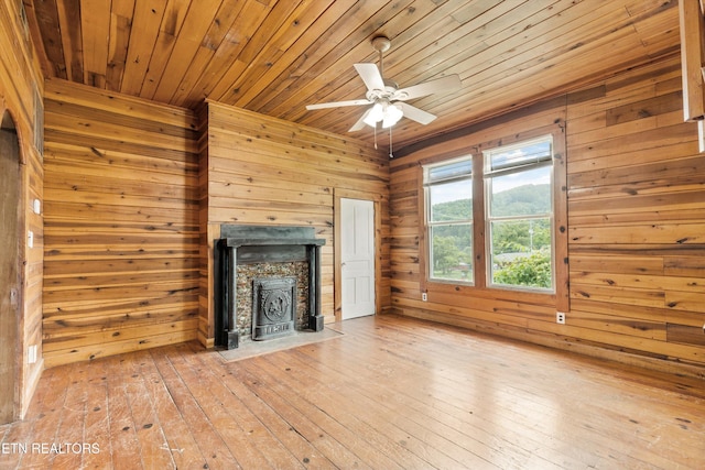 313 W Spring St, Oliver Springs, TN 37840 - unfurnished living room featuring wood walls, wood ceiling, a ceiling fan, and hardwood / wood-style floors