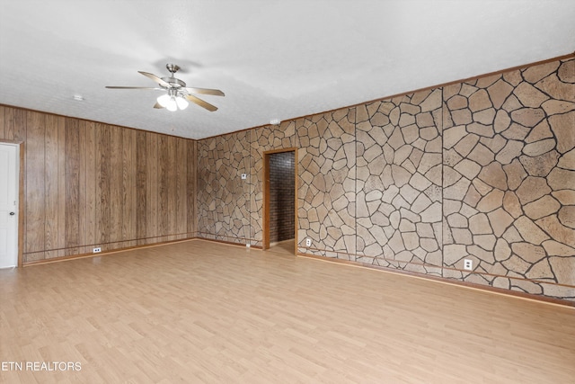 313 W Spring St, Oliver Springs, TN 37840 - empty room with ceiling fan, wood finished floors, wooden walls, and baseboards