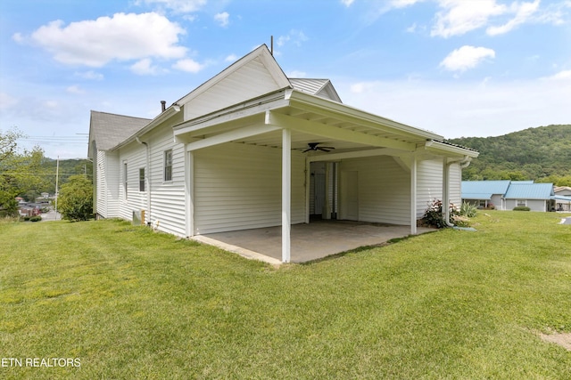 313 W Spring St, Oliver Springs, TN 37840 - view of home's exterior featuring a yard, ceiling fan, a carport, and a patio area