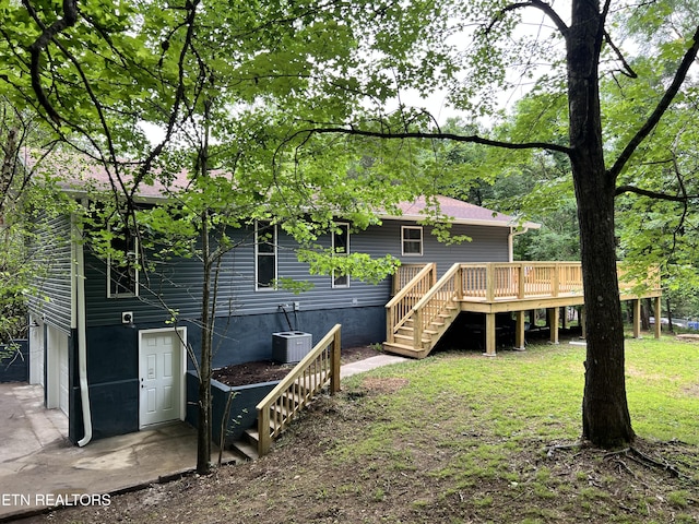 rear view of house featuring stairway, a wooden deck, and central air condition unit