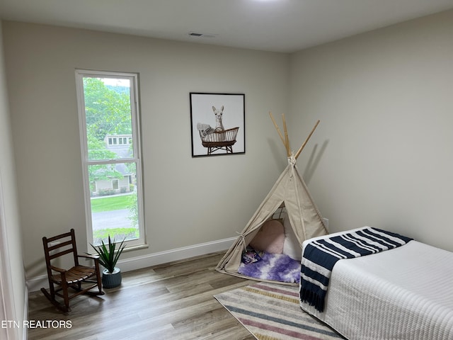 bedroom featuring wood finished floors and baseboards