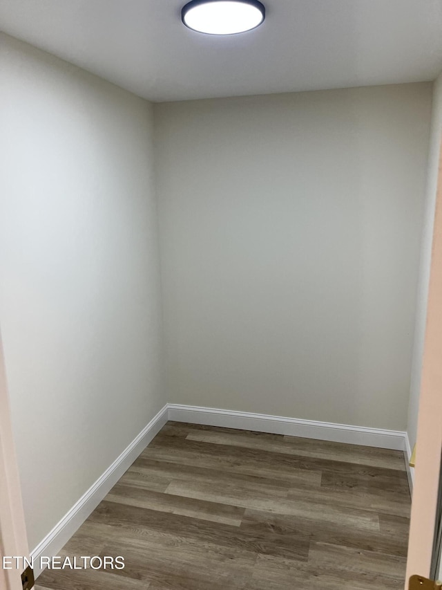 empty room featuring baseboards and wood finished floors