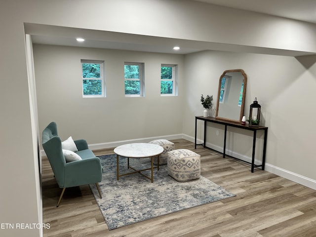 living area with wood finished floors, baseboards, and recessed lighting