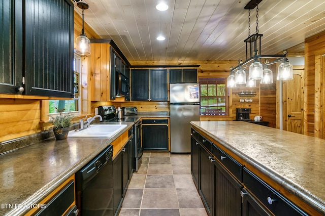 3330 Robeson Rd, Sevierville, TN 37862 - kitchen with black appliances, a sink, wood walls, decorative light fixtures, and recessed lighting