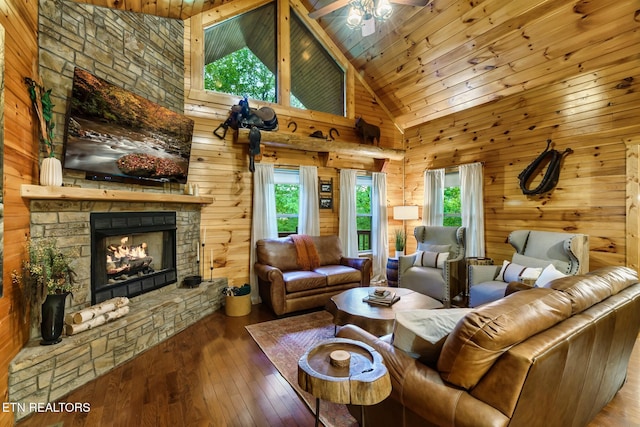 3330 Robeson Rd, Sevierville, TN 37862 - living room with a stone fireplace, healthy amount of natural light, hardwood / wood-style floors, wooden ceiling, and wooden walls