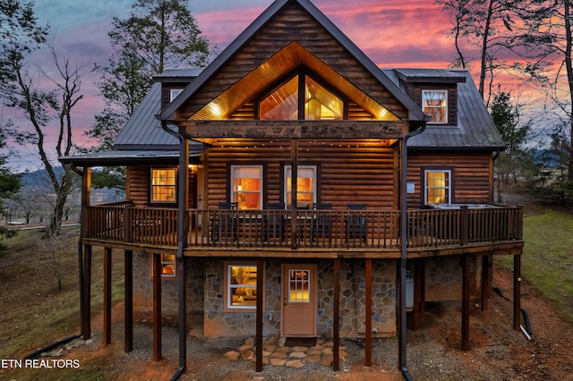3330 Robeson Rd, Sevierville, TN 37862 - back of property at dusk featuring a deck, metal roof, and log veneer siding