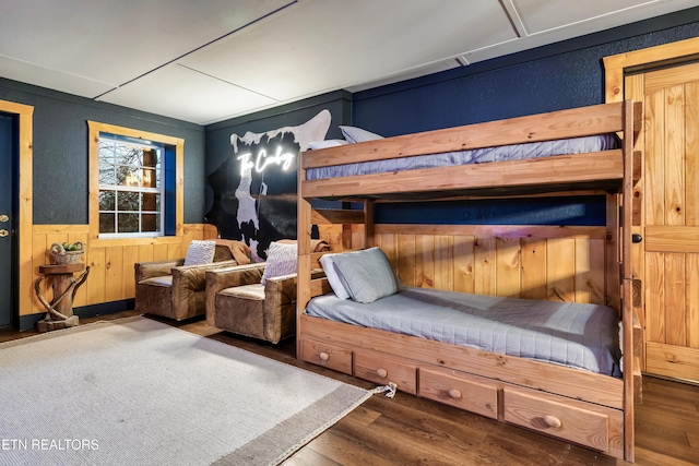 3330 Robeson Rd, Sevierville, TN 37862 - bedroom featuring wood finished floors, a wainscoted wall, and wooden walls