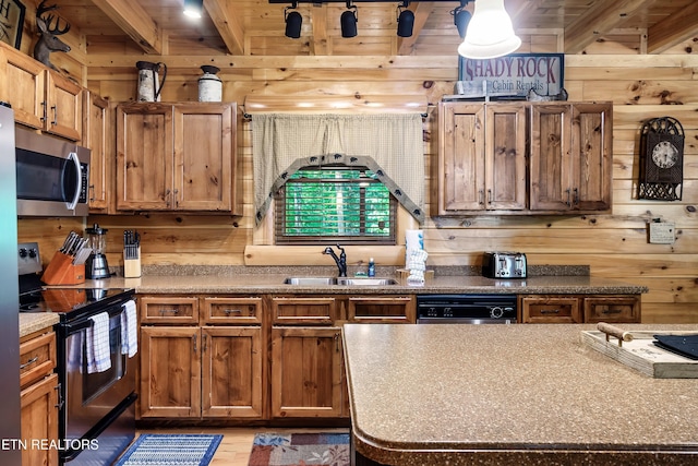 kitchen featuring stainless steel appliances, a sink, wood walls, beamed ceiling, and wooden ceiling