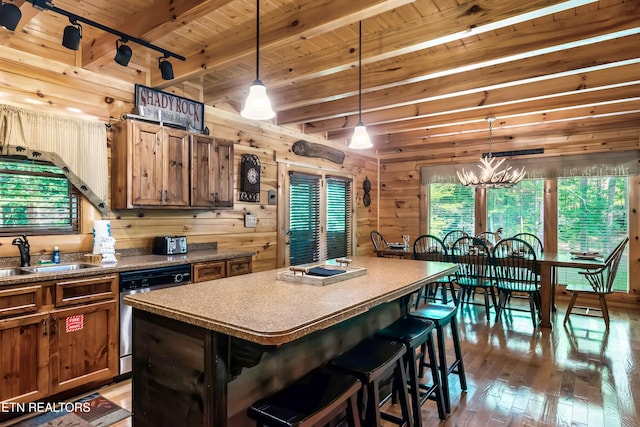 kitchen featuring a sink, dishwashing machine, wood ceiling, hardwood / wood-style floors, and wooden walls