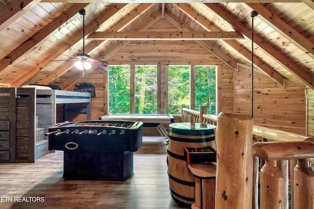 game room with wooden walls, wood ceiling, hardwood / wood-style floors, and a ceiling fan