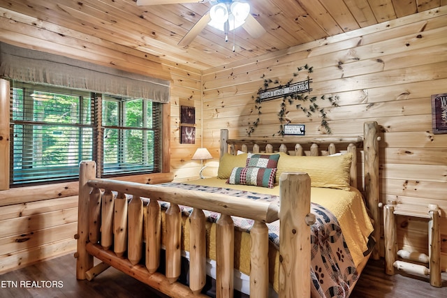 bedroom with wood finished floors, wood ceiling, wood walls, and ceiling fan