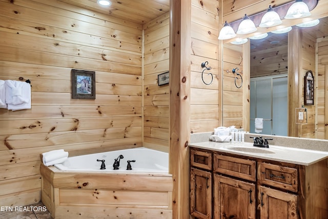 full bath with a bath, wood walls, and vanity