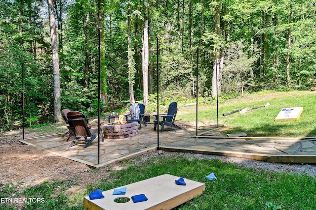 view of green lawn featuring a fire pit