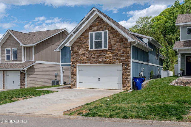3132 Bakertown Station Way, Knoxville, TN 37931 - craftsman inspired home featuring stone siding, a garage, driveway, a front lawn, and roof with shingles