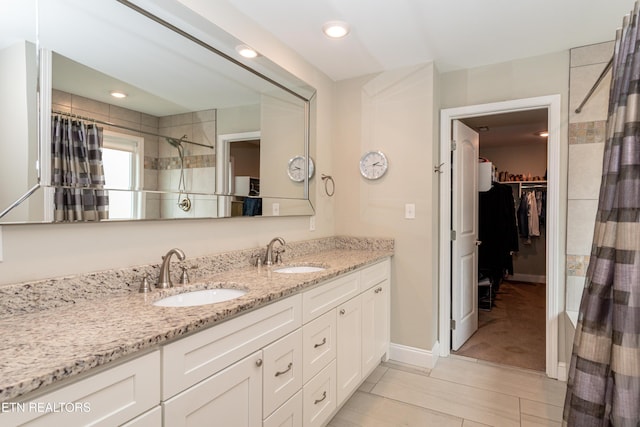 3132 Bakertown Station Way, Knoxville, TN 37931 - bathroom with double vanity, a spacious closet, tiled shower, and recessed lighting