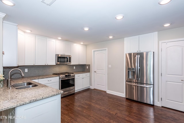 3132 Bakertown Station Way, Knoxville, TN 37931 - kitchen with stainless steel appliances, dark wood-style floors, light stone countertops, white cabinets, and recessed lighting