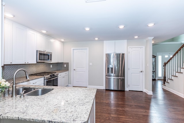 3132 Bakertown Station Way, Knoxville, TN 37931 - kitchen with stainless steel appliances, light stone counters, tasteful backsplash, dark wood finished floors, and white cabinets