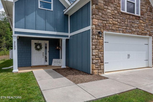 3132 Bakertown Station Way, Knoxville, TN 37931 - property entrance featuring stone siding, board and batten siding, an attached garage, and concrete driveway