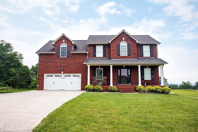 158 Dudley Cir, Tazewell, TN 37879 - view of front of home with brick siding, driveway, an attached garage, a front yard, and covered porch