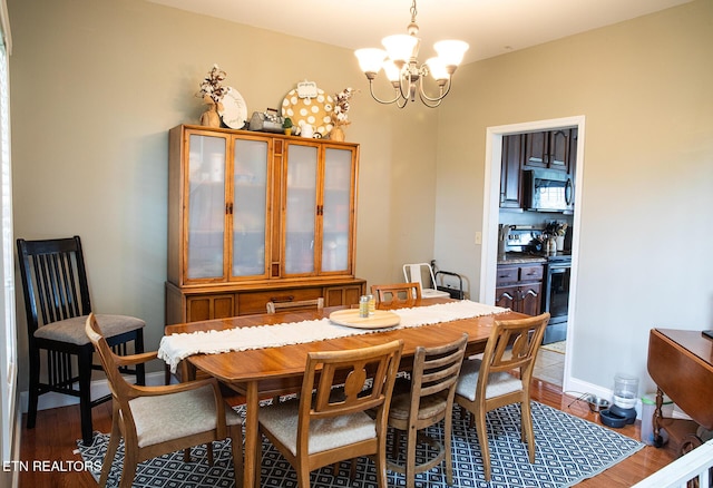158 Dudley Cir, Tazewell, TN 37879 - dining area featuring a chandelier, wood finished floors, and baseboards
