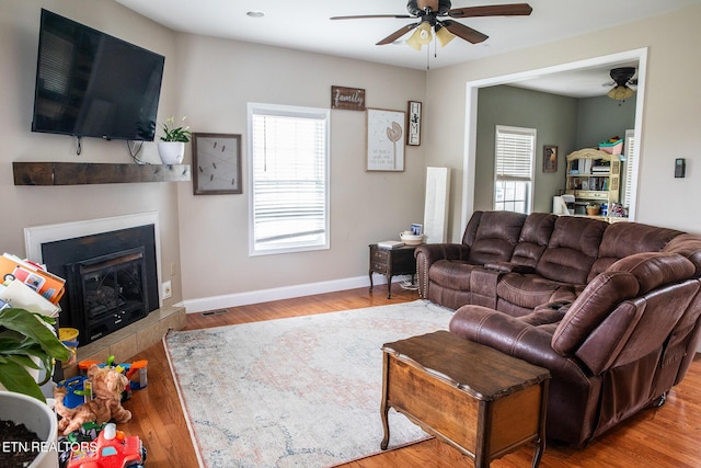 158 Dudley Cir, Tazewell, TN 37879 - living area featuring ceiling fan, a glass covered fireplace, baseboards, and wood finished floors