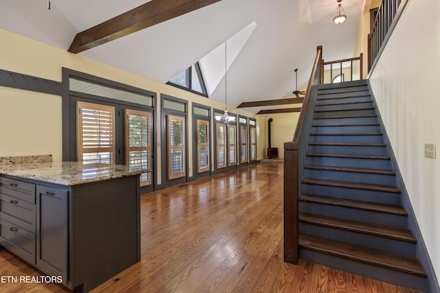 310 Savannah Shores Dr, Delano, TN 37325 - kitchen with high vaulted ceiling, light stone counters, wood finished floors, beam ceiling, and open floor plan