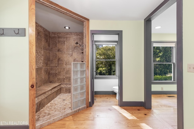 310 Savannah Shores Dr, Delano, TN 37325 - bathroom with walk in shower, toilet, wood finished floors, and baseboards