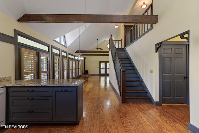 310 Savannah Shores Dr, Delano, TN 37325 - kitchen with wood finished floors, beam ceiling, high vaulted ceiling, light stone counters, and baseboards